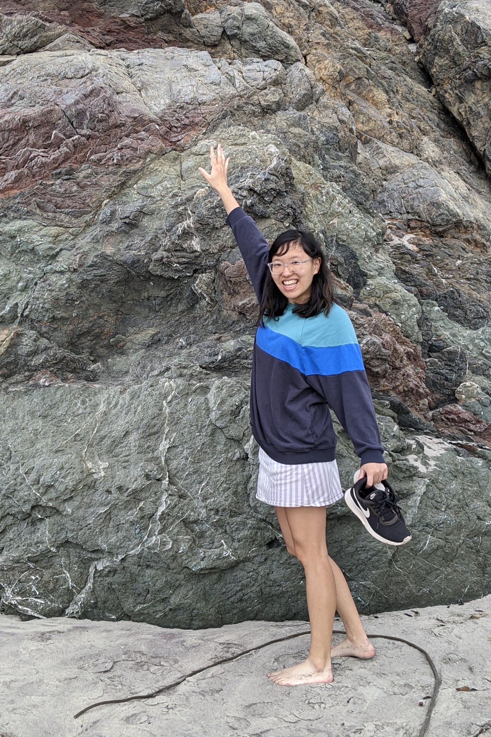 Lucy Li in a sweater with a big rock