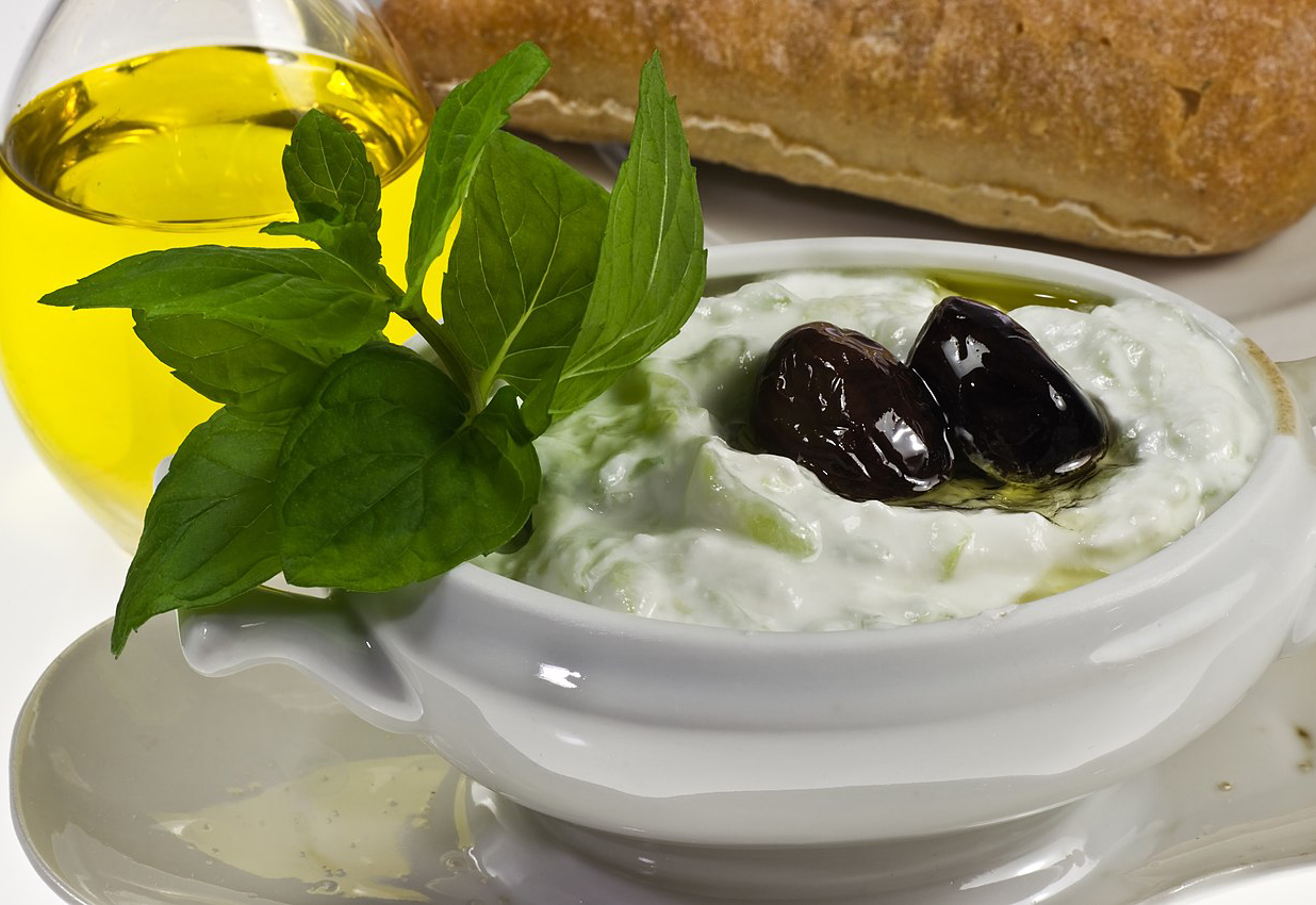 a yogurt dip with olives and olive oil